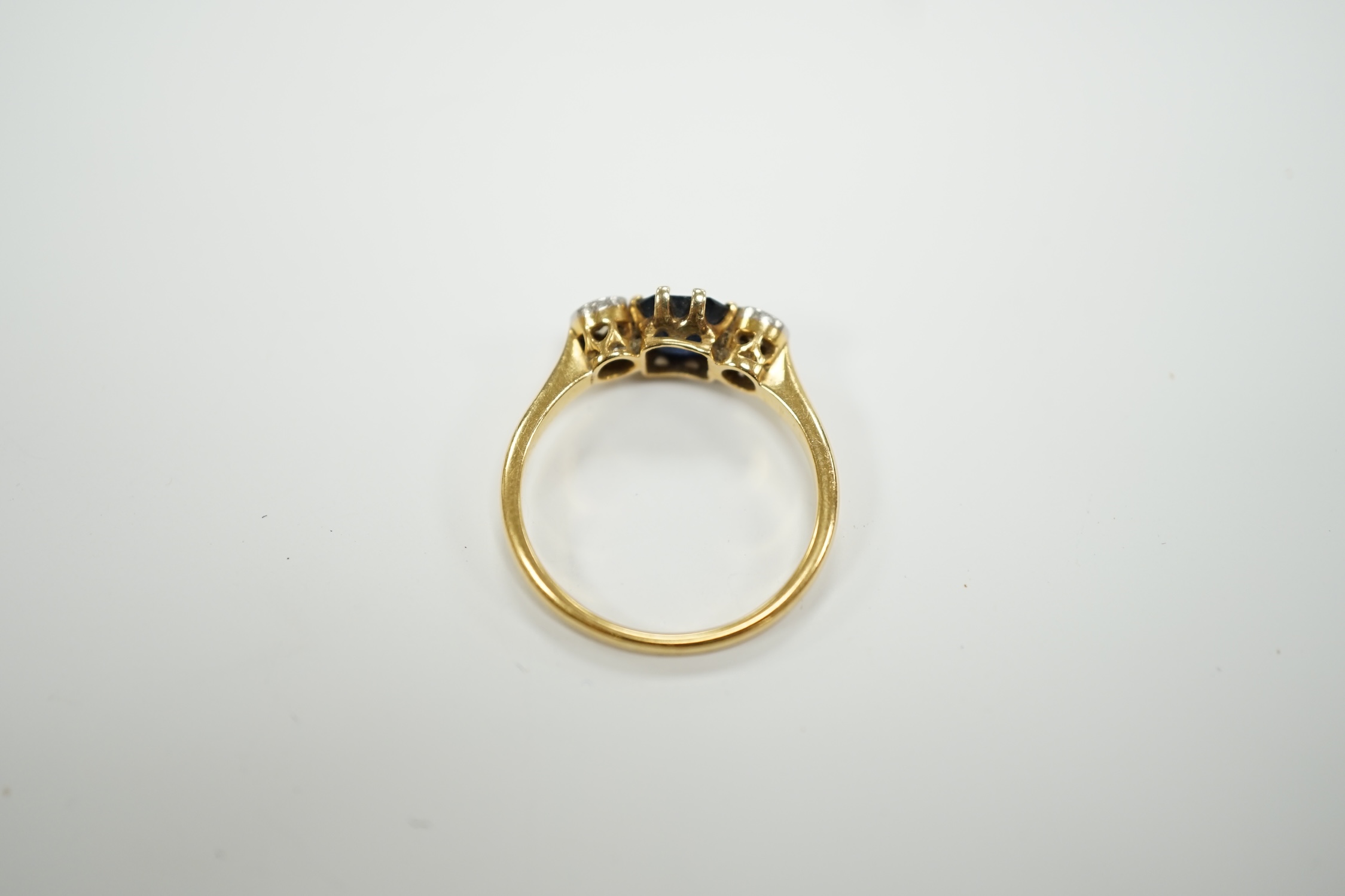 An 18ct and plat, single stone sapphire and two stone diamond set ring, size O/P, gross weight 3.1 grams.